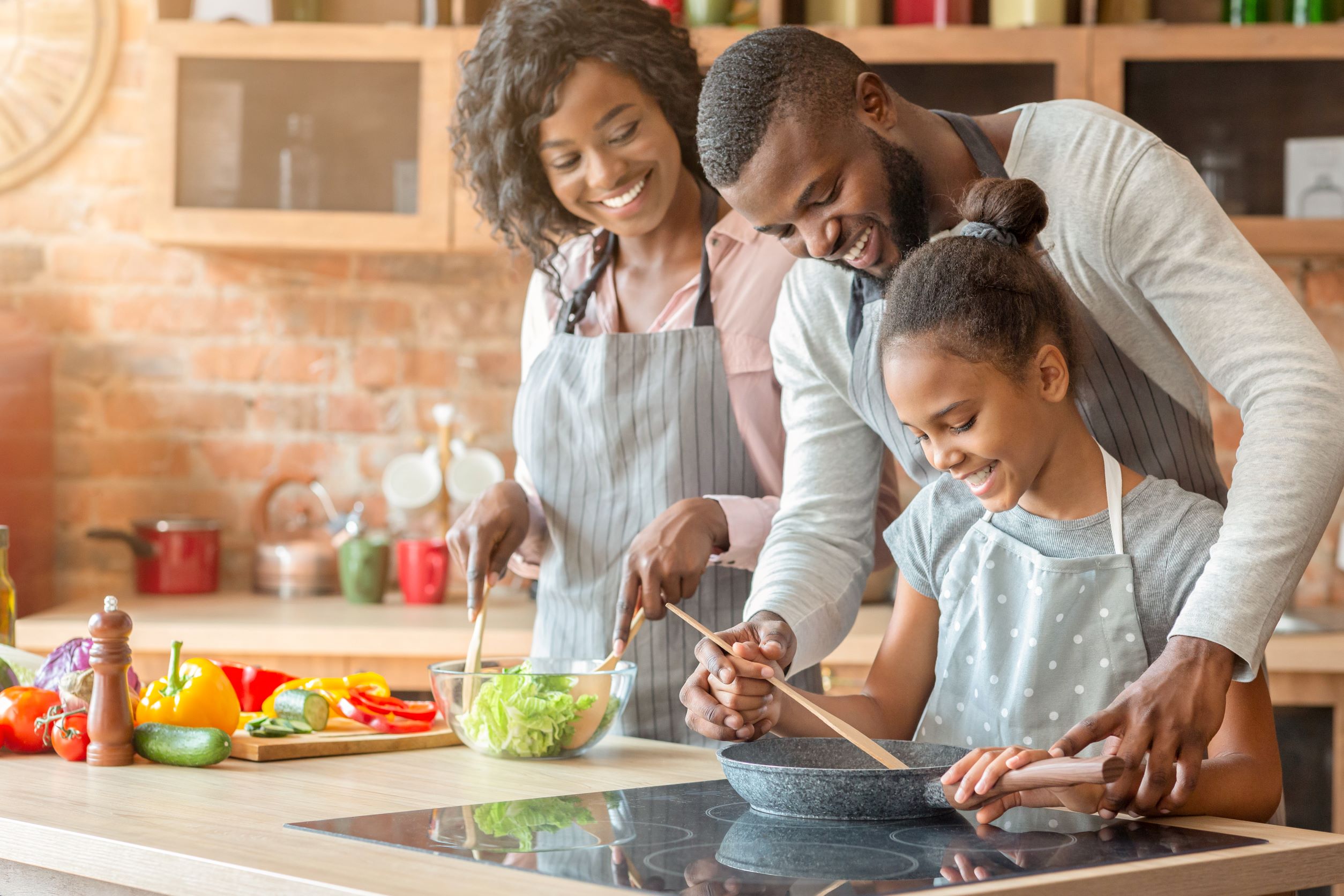 A family cooks on an induction stove.